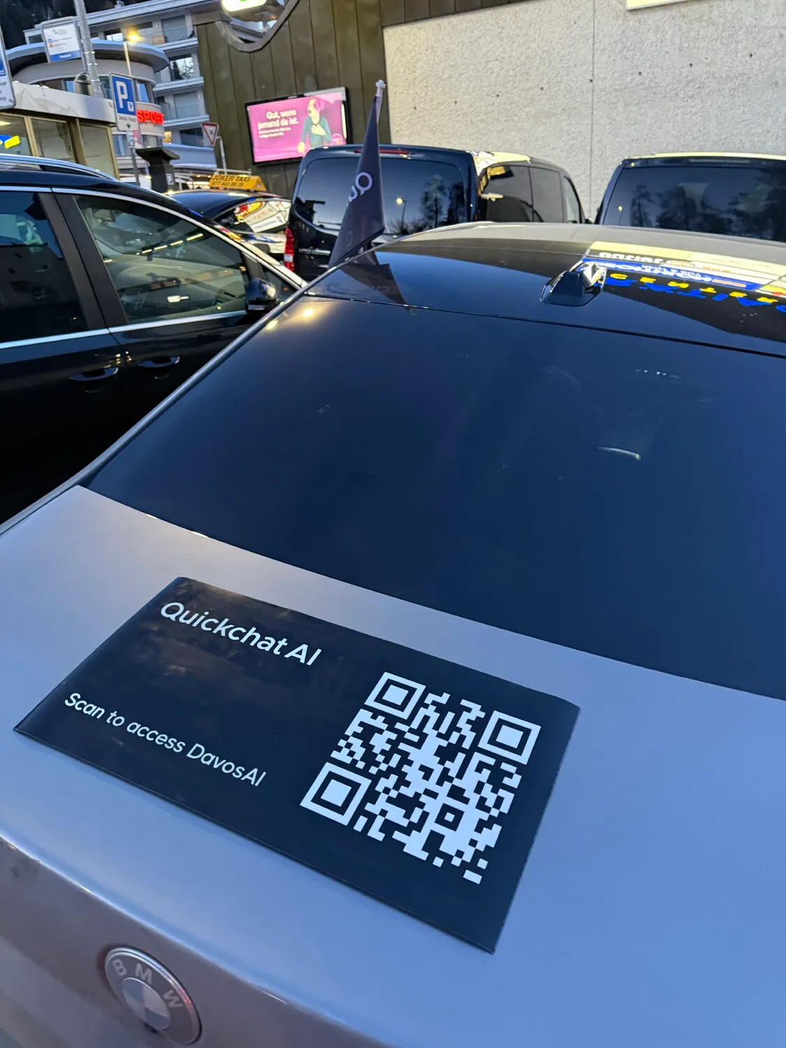 Car with Quickchat AI branding and QR code in Davos